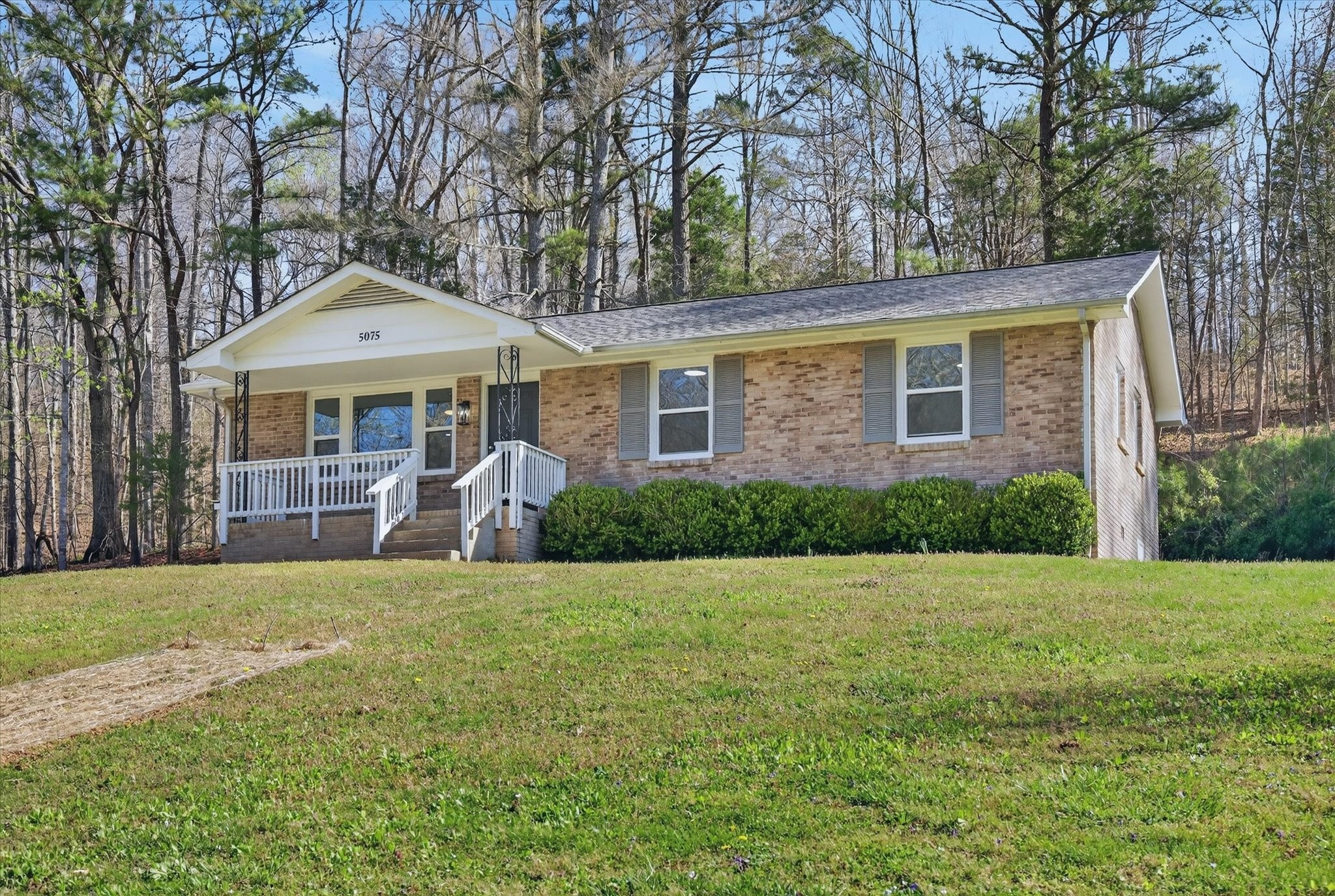 5075 Logan Road Cunningham, TN 37052 - Photo 4 of 22 a front view of a house with a garden
