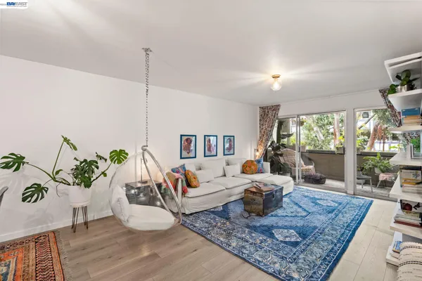 a bedroom with two beds and potted plant next to a window