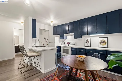 a kitchen with stainless steel appliances stove top oven and cabinets