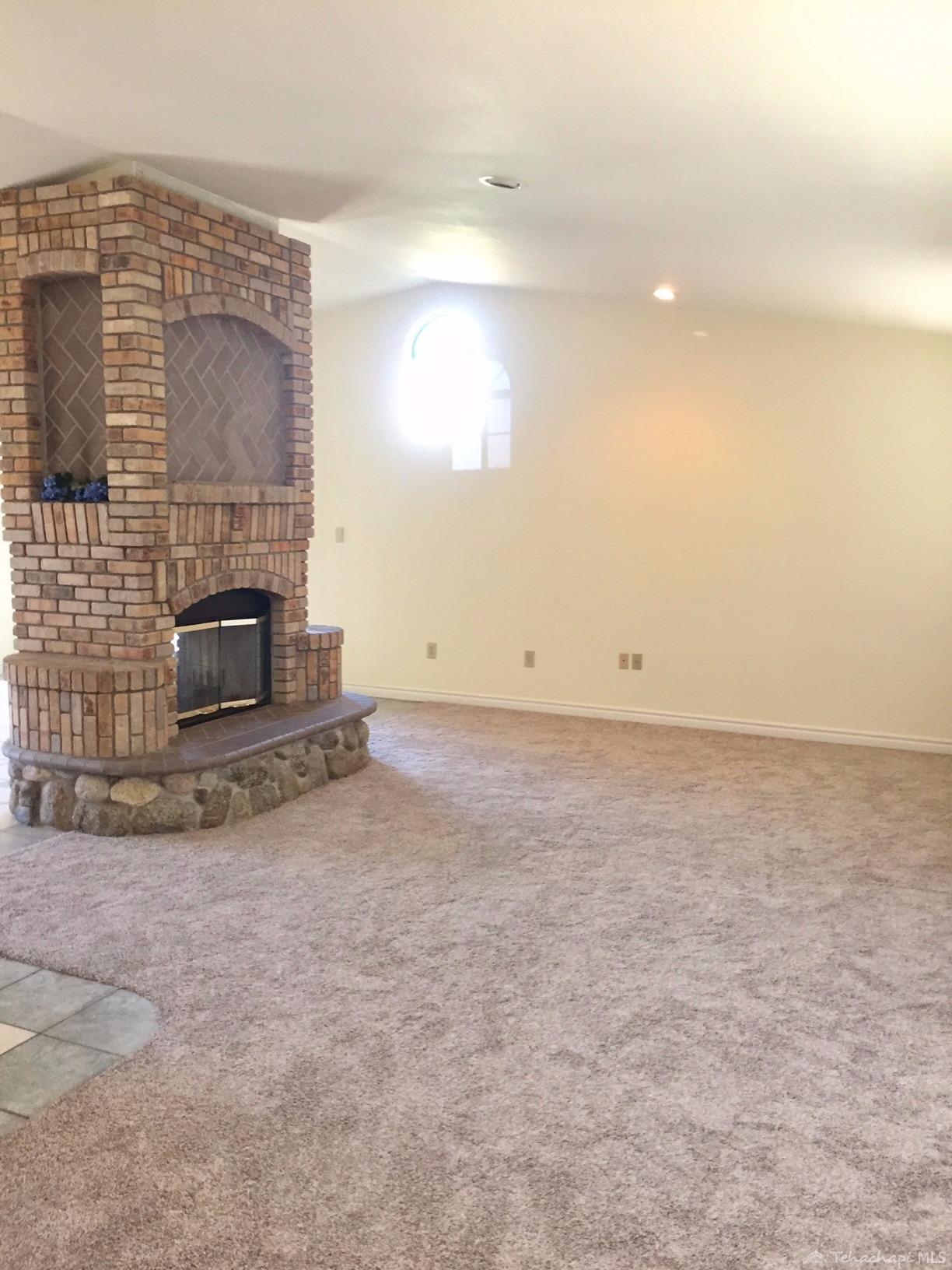 21701 Ripple Lane Tehachapi, CA 93561 - Photo 18 of 33 LIVING ROOM WITH DOUBLE SIDED FIREPLACE