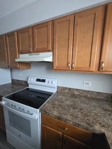 a kitchen with granite countertop cabinets washer and dryer