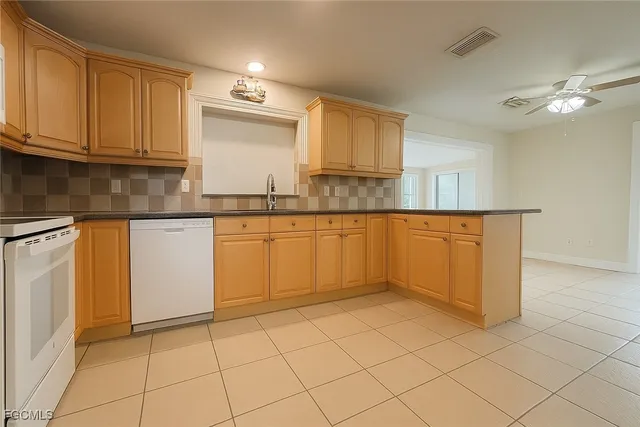 a kitchen with white cabinets
