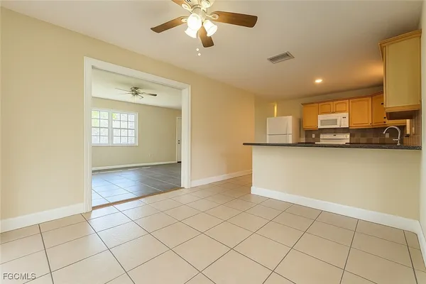 a view of a kitchen with a sink and dishwasher cabinets