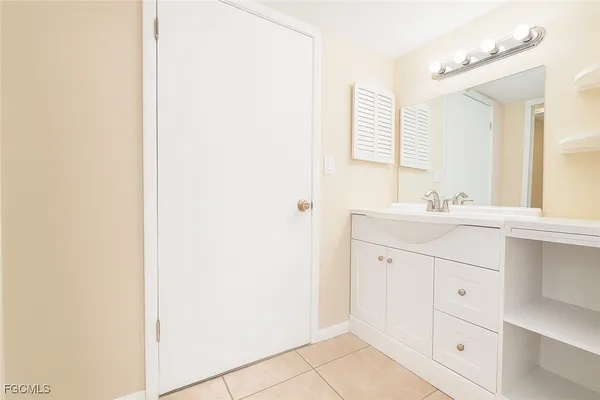 a bathroom with a sink vanity and a mirror