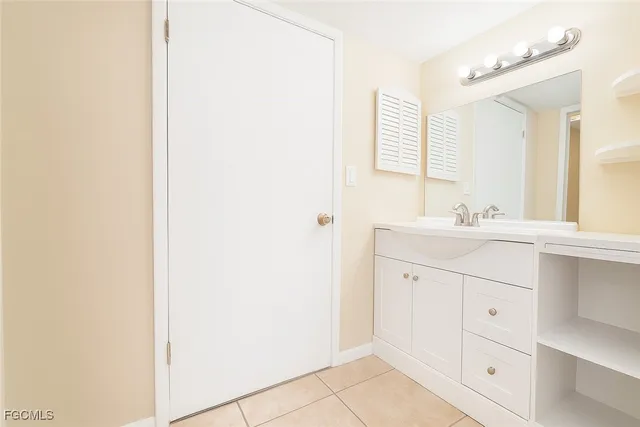 a bathroom with a sink vanity and a mirror