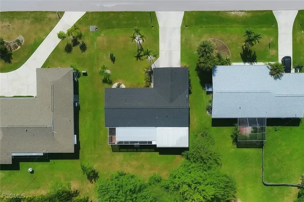 an aerial view of a house with swimming pool garden and patio