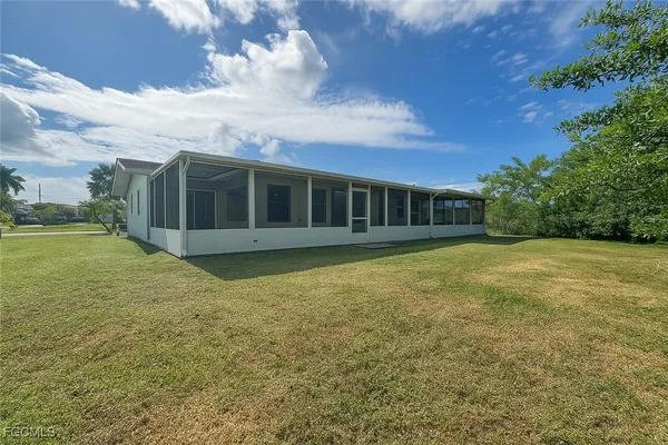 a view of a house with a backyard