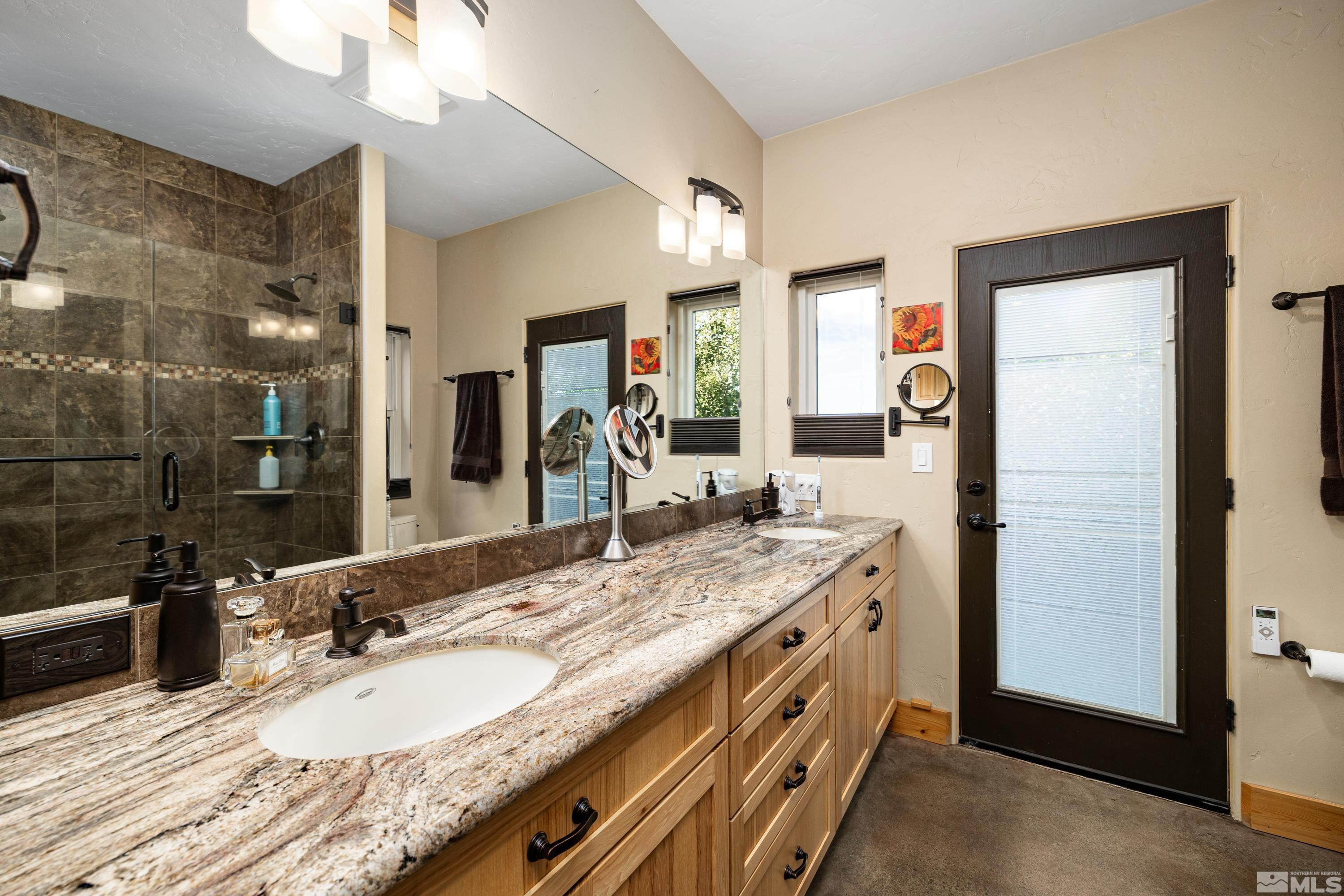 5745 Carl Drive Reno, NV 89511 - Photo 13 of 40 a bathroom with a granite countertop double vanity sink and a mirror