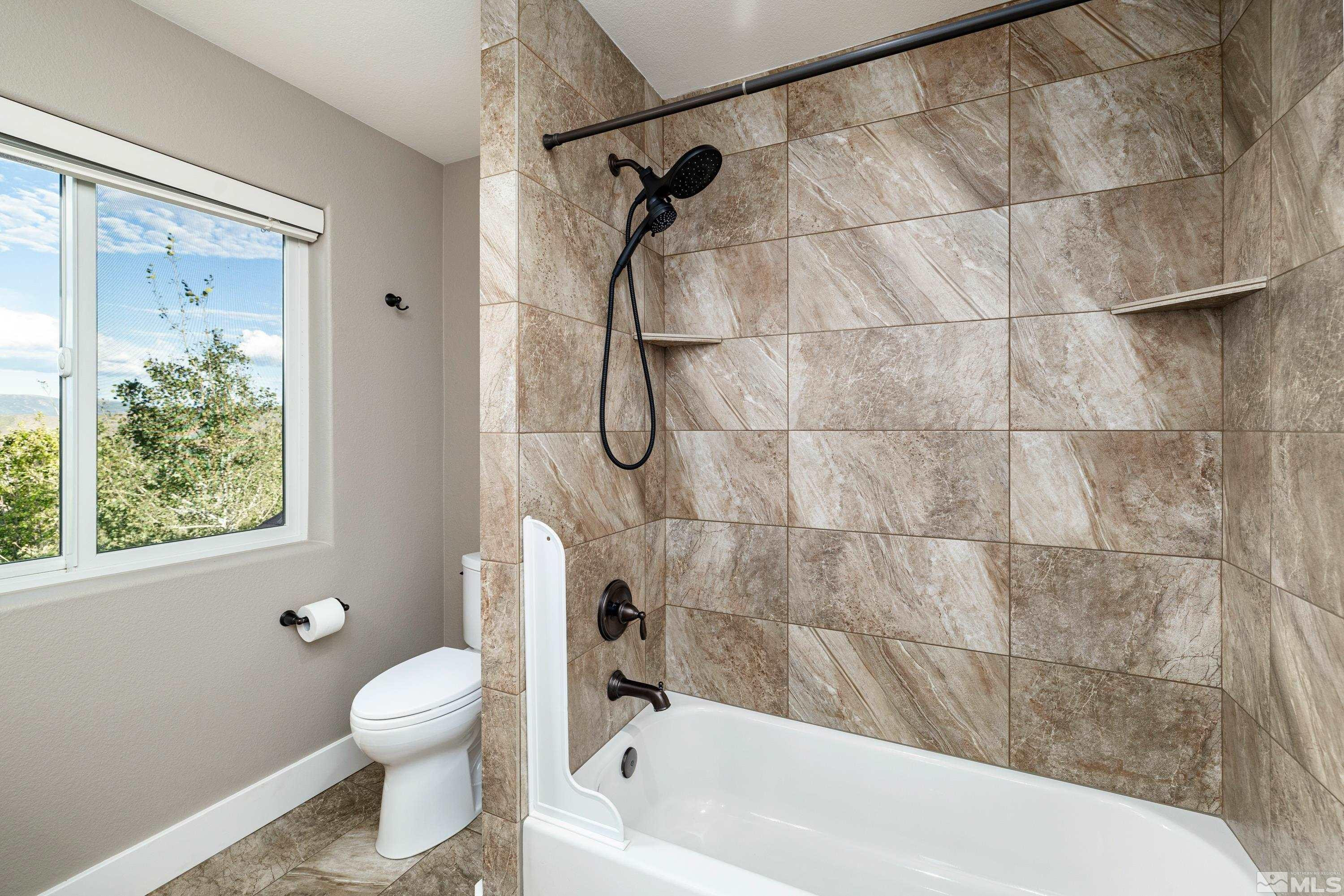 5745 Carl Drive Reno, NV 89511 - Photo 30 of 40 a bathroom with a toilet and shower