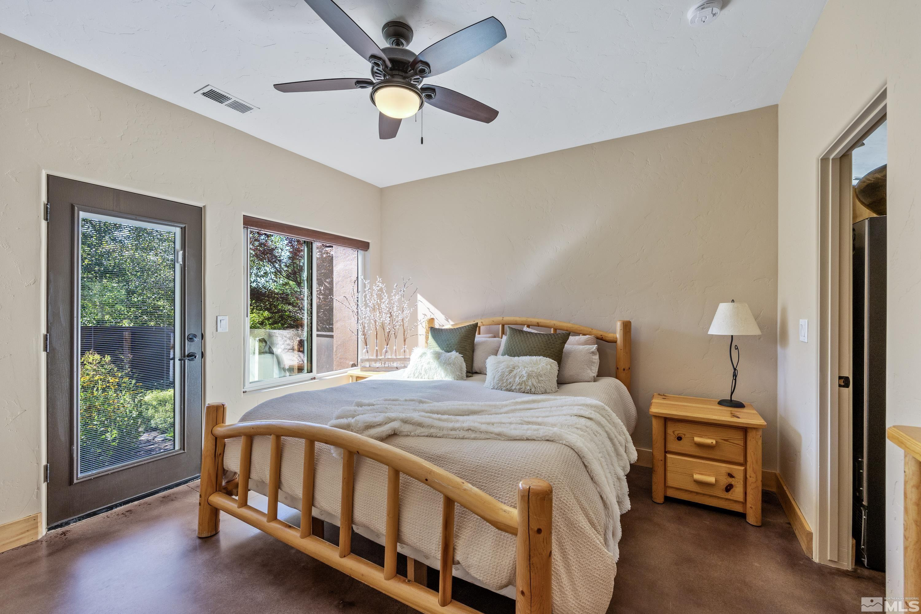 5745 Carl Drive Reno, NV 89511 - Photo 10 of 40 a bedroom with a large bed and a tv