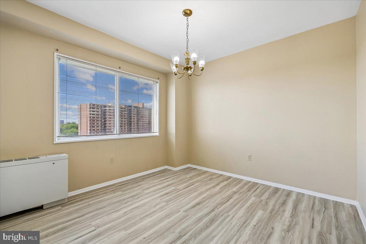 1111 University Boulevard West, Unit 1106A Silver Spring, MD 20902 - Photo 7 of 35 a view of empty room with wooden floor and windows