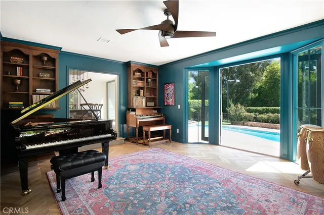 a living room with furniture a rug and a large window