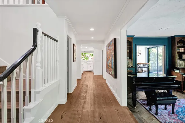 a view of a hallway view with wooden floor and staircase