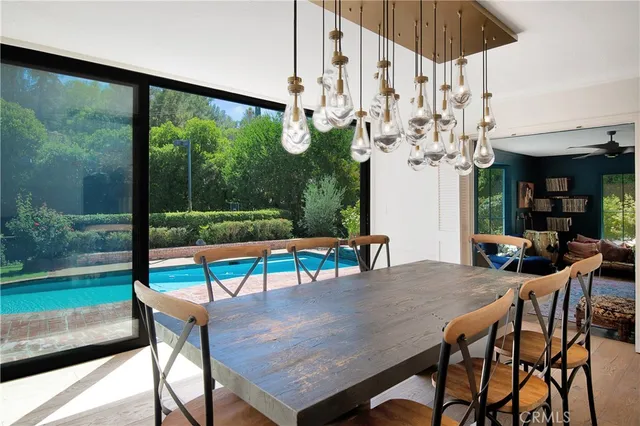 a view of a dining room with furniture a chandelier and pool table
