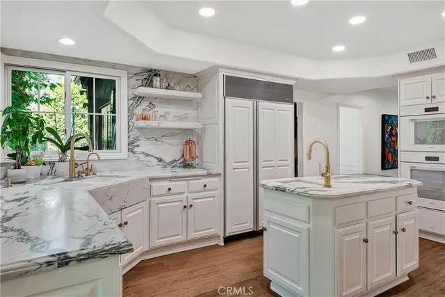 a spacious kitchen with stainless steel appliances granite countertop a sink stove and cabinets