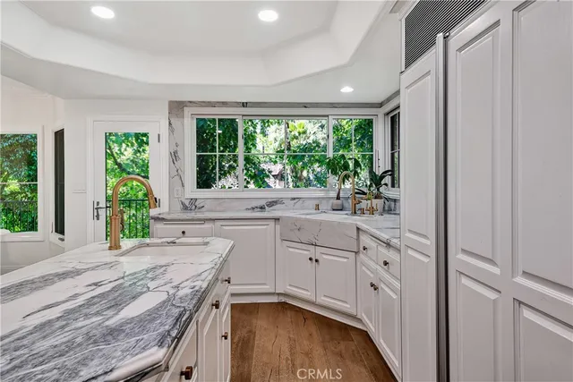 a kitchen with sink refrigerator and large window