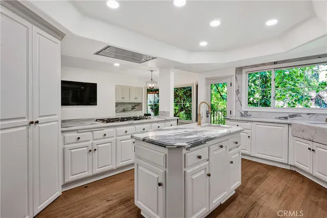 a kitchen with granite countertop white cabinets and white appliances
