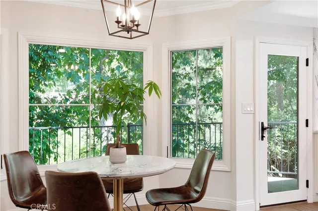a living room with furniture a fireplace and a floor to ceiling window