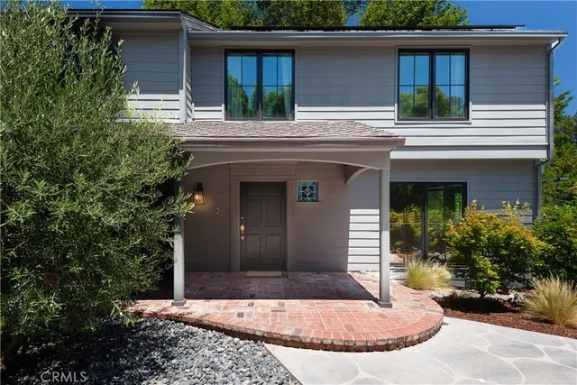 a view of a house with a window and potted plants