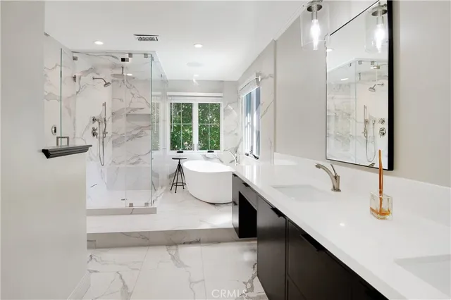 a white bath tub sitting in a bathroom next to a window