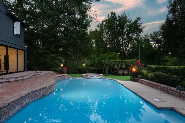 a view of a wooden deck and a backyard