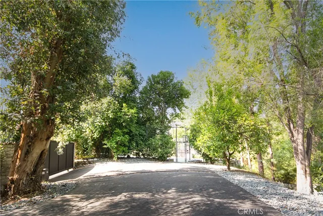 a view of a street with trees on both side of it