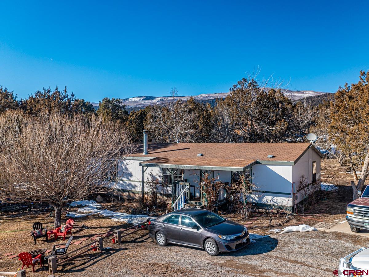 19987 Green Valley Road Cedaredge, CO 81413 - Photo 1 of 25 a car parked in front of a house