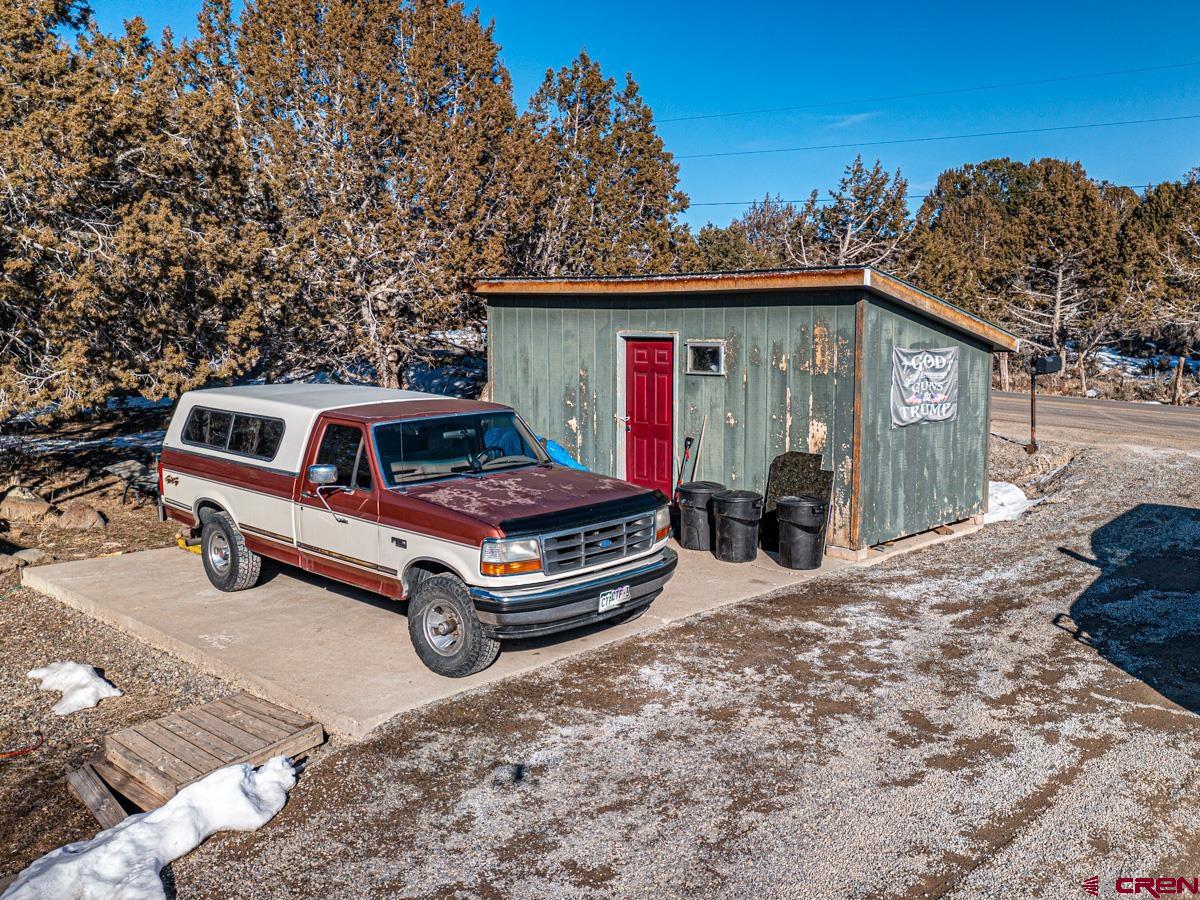 19987 Green Valley Road Cedaredge, CO 81413 - Photo 18 of 25 a car parked in front of a house