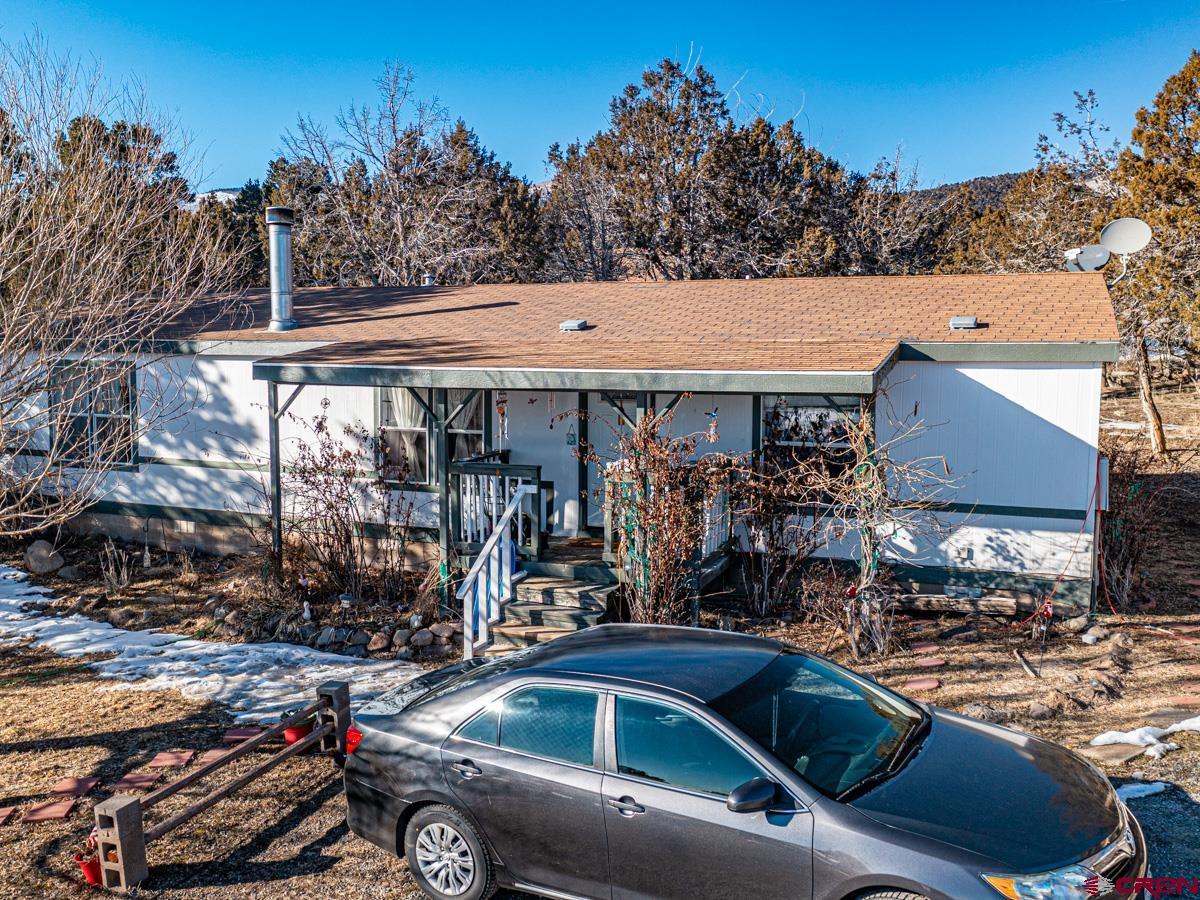 19987 Green Valley Road Cedaredge, CO 81413 - Photo 2 of 25 a car parked in front of a house