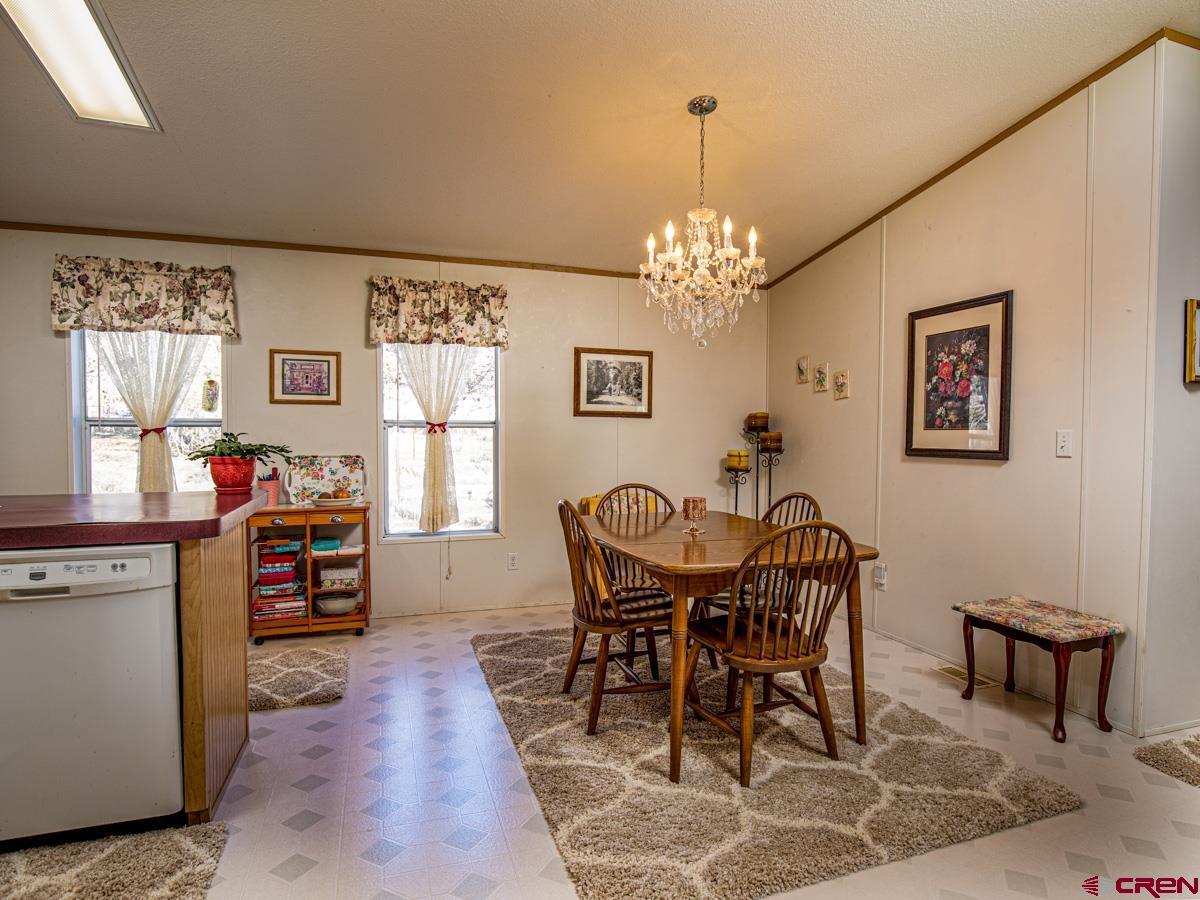 19987 Green Valley Road Cedaredge, CO 81413 - Photo 8 of 25 a view of a dining room with furniture window and wooden floor