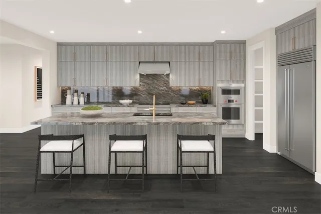 a kitchen with a sink cabinets and wooden floor