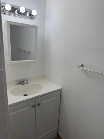 a bathroom with a sink and mirror
