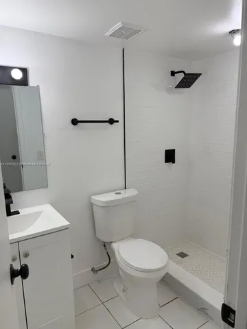a white toilet sitting next to a bathroom sink