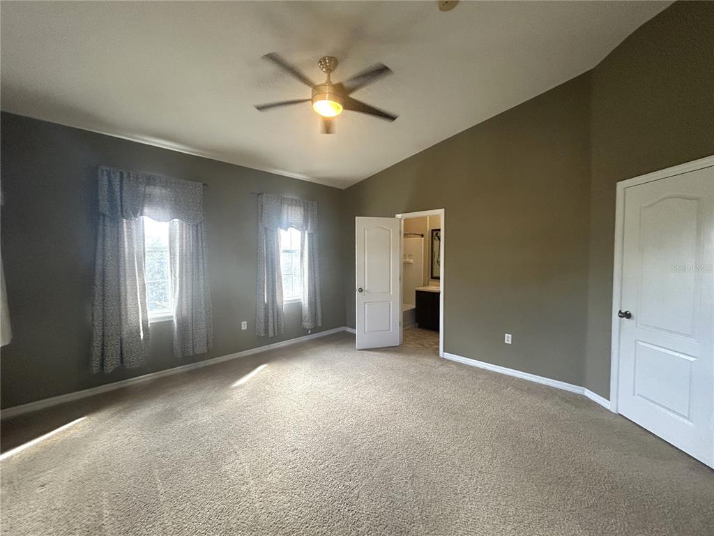 9036 Moonlit Meadows Loop Riverview, FL 33578 - Photo 12 of 20 an empty room with windows and chandelier fan