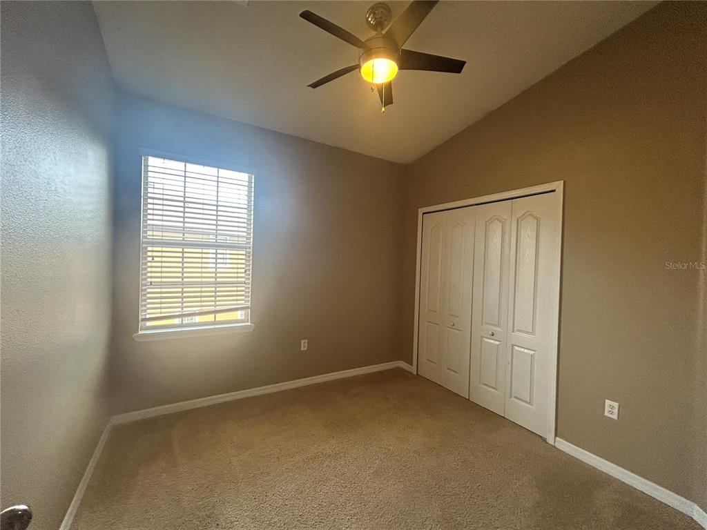 9036 Moonlit Meadows Loop Riverview, FL 33578 - Photo 13 of 20 an empty room with a window and a fan