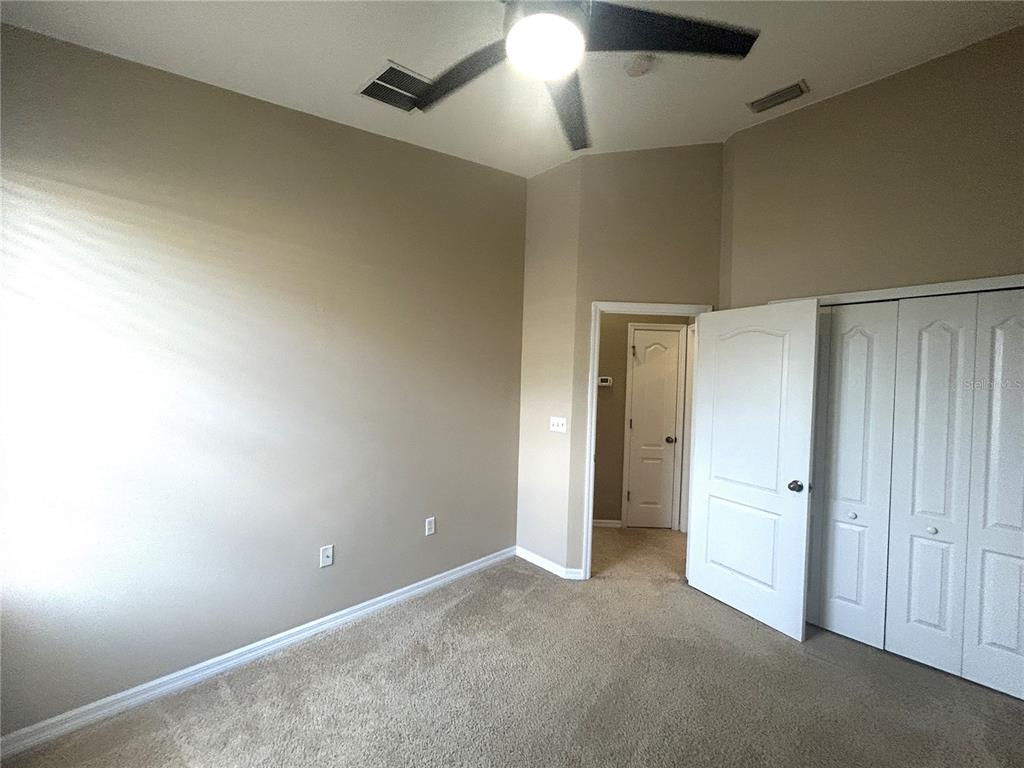 9036 Moonlit Meadows Loop Riverview, FL 33578 - Photo 16 of 20 an empty room with an entryway and chandelier fan