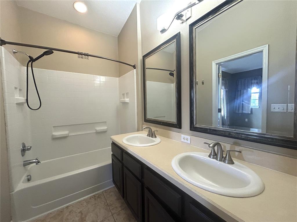 9036 Moonlit Meadows Loop Riverview, FL 33578 - Photo 17 of 20 a bathroom with a sink and a mirror