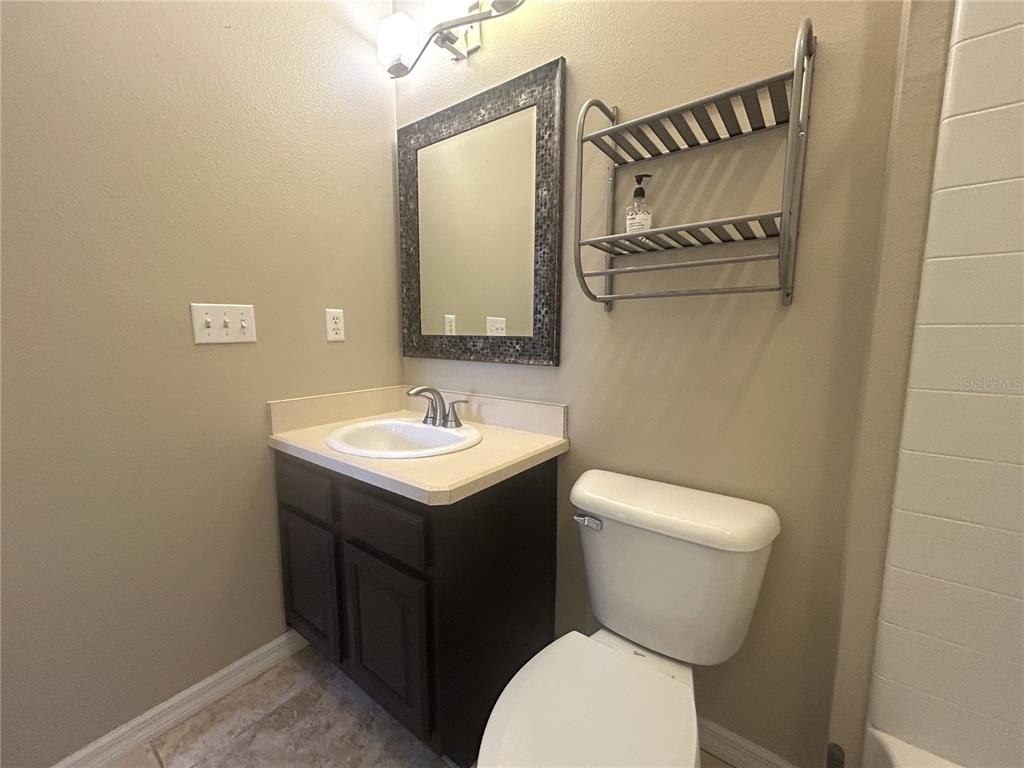 9036 Moonlit Meadows Loop Riverview, FL 33578 - Photo 18 of 20 a bathroom with a toilet sink and mirror