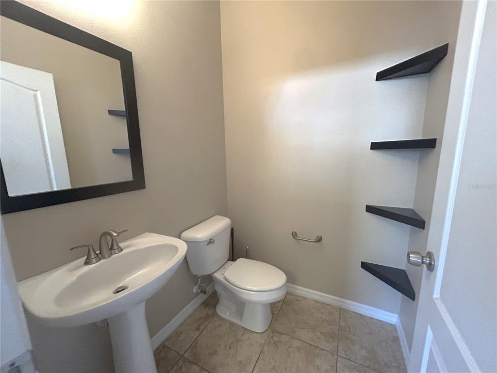9036 Moonlit Meadows Loop Riverview, FL 33578 - Photo 19 of 20 a bathroom with a toilet sink and mirror