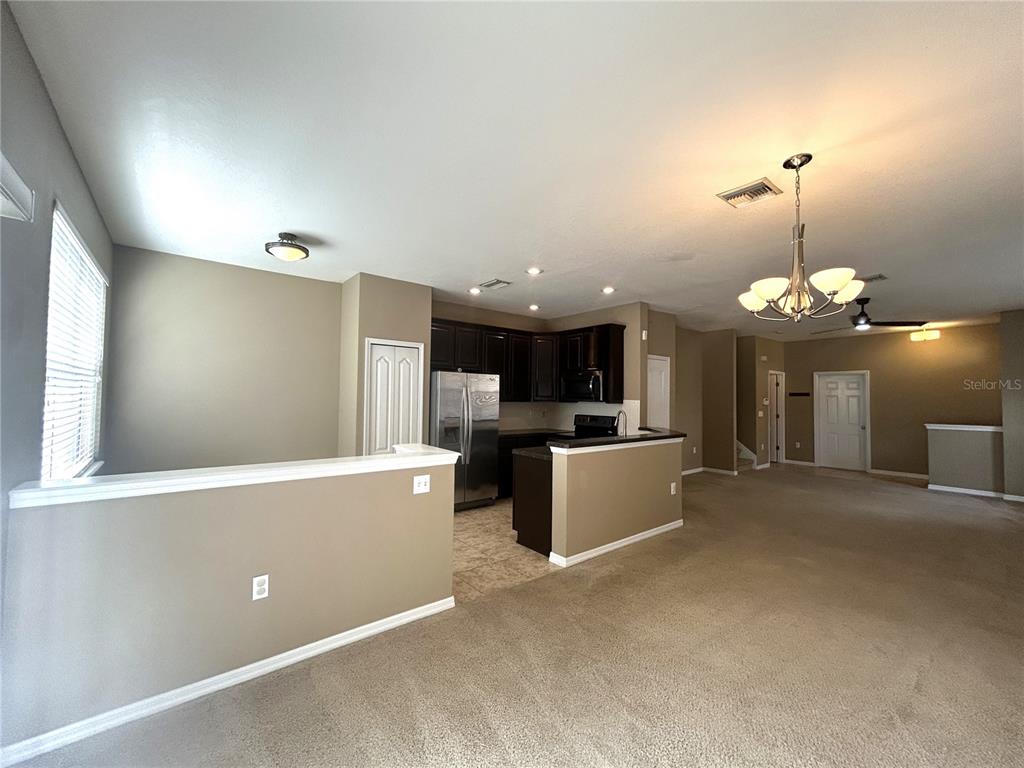 9036 Moonlit Meadows Loop Riverview, FL 33578 - Photo 8 of 20 a view of a kitchen with a sink and chandelier