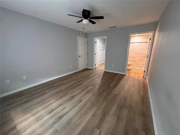 a view of a room with wooden floor
