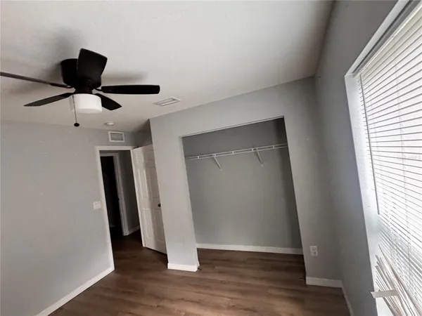 a large kitchen with a sink and dishwasher a stove top oven with wooden floor