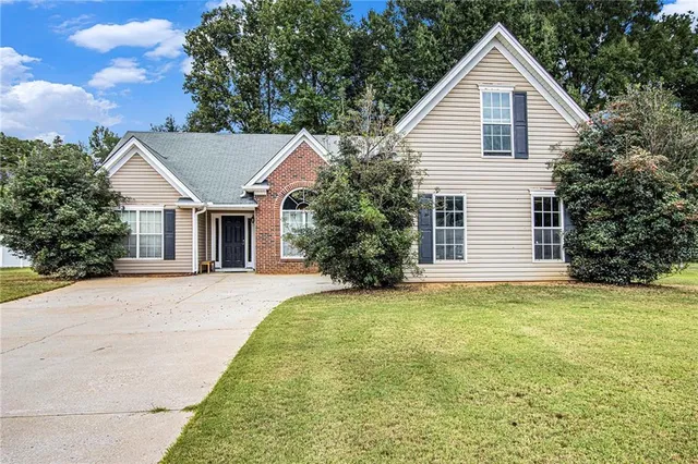 a front view of a house with a garden