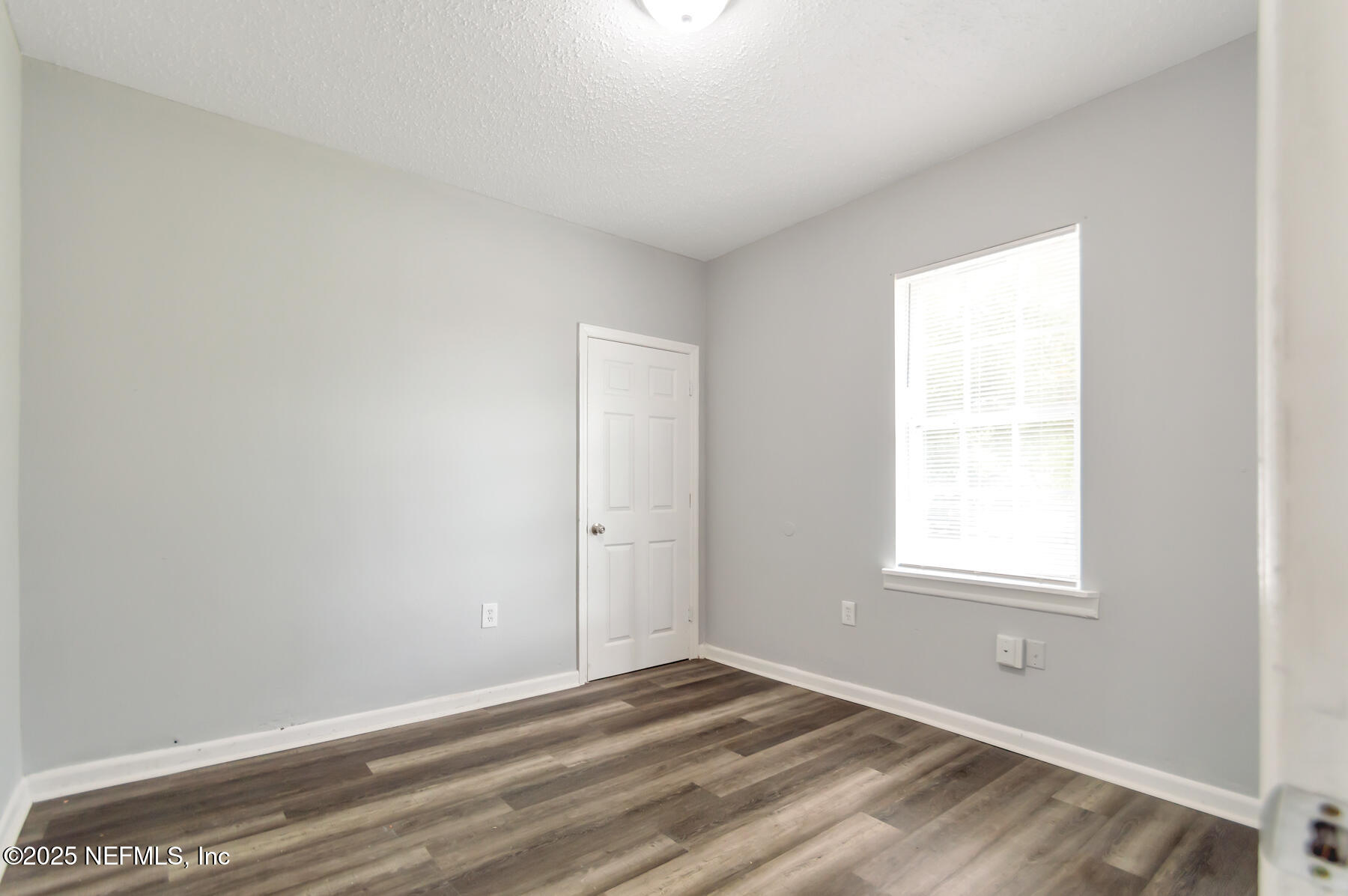 1165 Hart Street Jacksonville, FL 32209 - Photo 18 of 22 a view of an empty room with wooden floor and a window