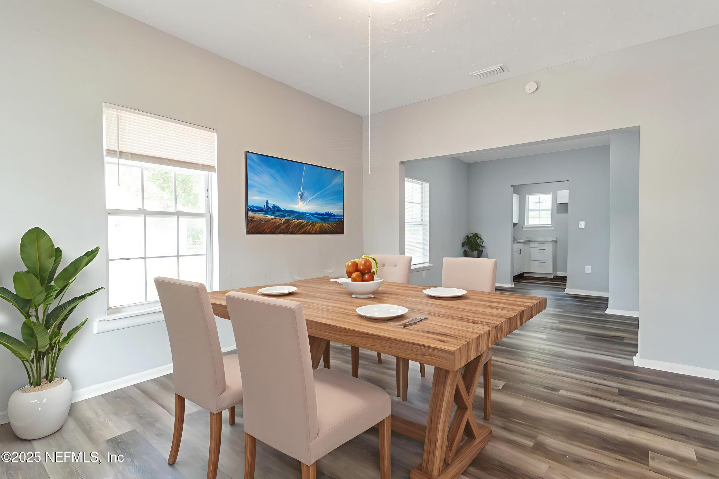 1165 Hart Street Jacksonville, FL 32209 - Photo 3 of 22 a dining room with furniture potted plants and wooden floor