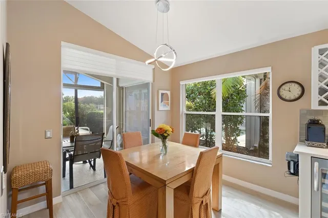 a dining room with furniture wooden floor a chandelier