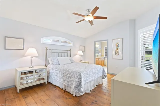 a bedroom with a bed a chandelier and a window