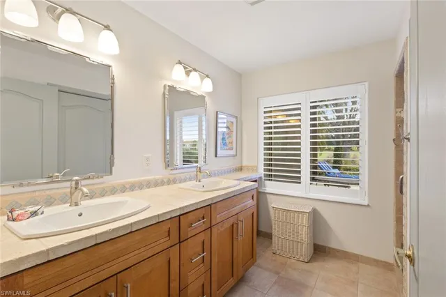 a bathroom with a sink double vanity and a two mirror