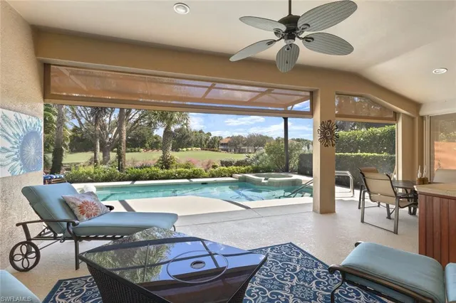 a living room with couch and a floor to ceiling window