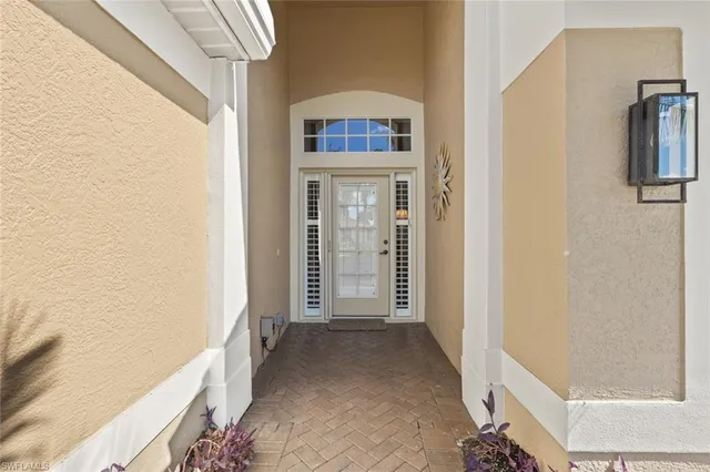 a view of a hallway with wooden floor and entryway